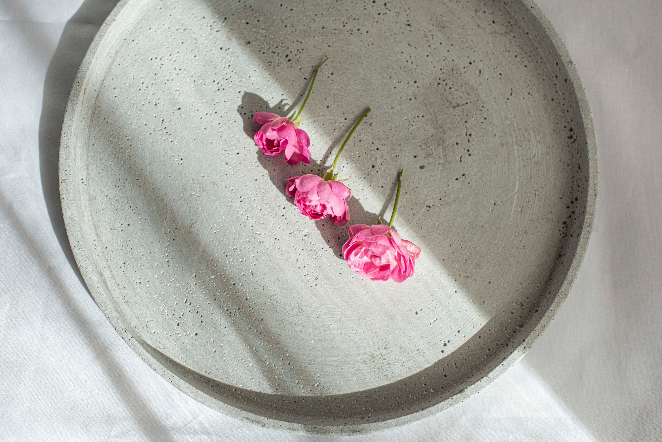 three pink roses on a plate