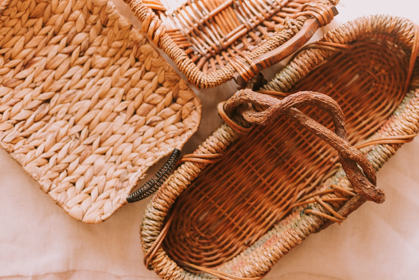 three woven baskets against brown background