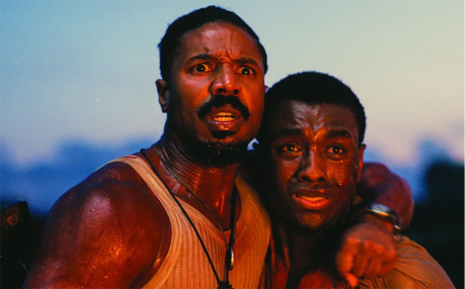 2 Black men looking at something in horror and scared, a still from the horror film Sinners